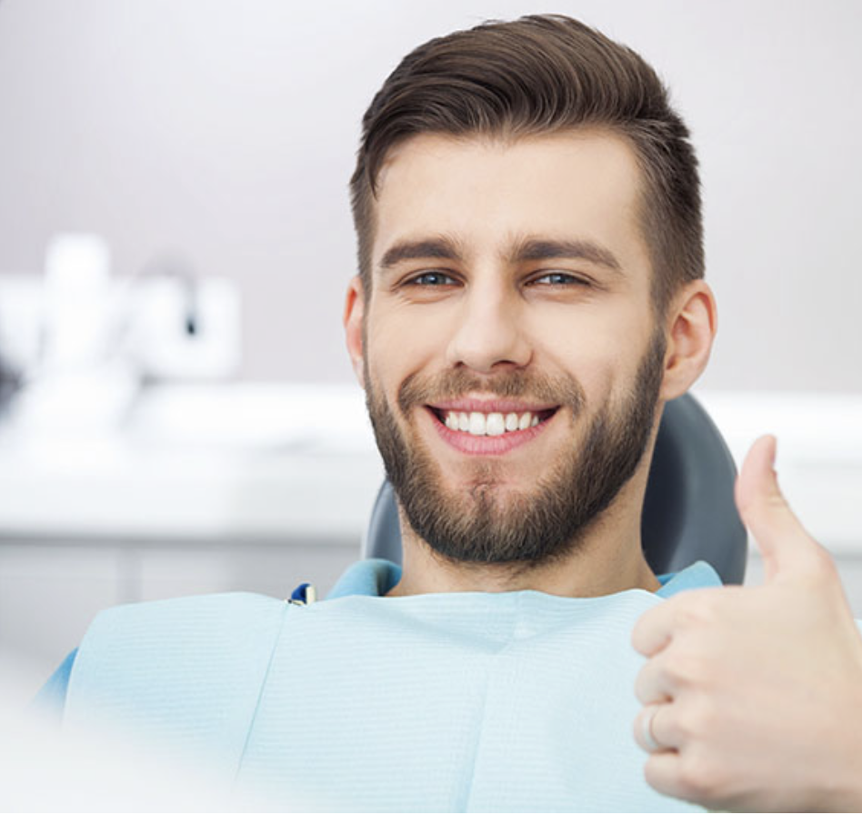 A man smiling after a successful root canal.